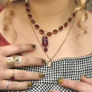 person wearing handmade beaded jewelry