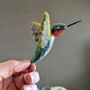 hand holding needle felted wool hummingbird