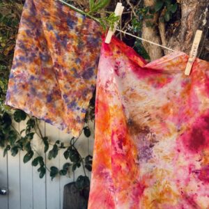 bundle dyed textiles hanging from a line outdoors