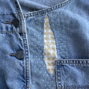 visible mending on jean fabric