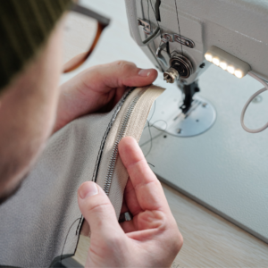 person holding sewed zipper