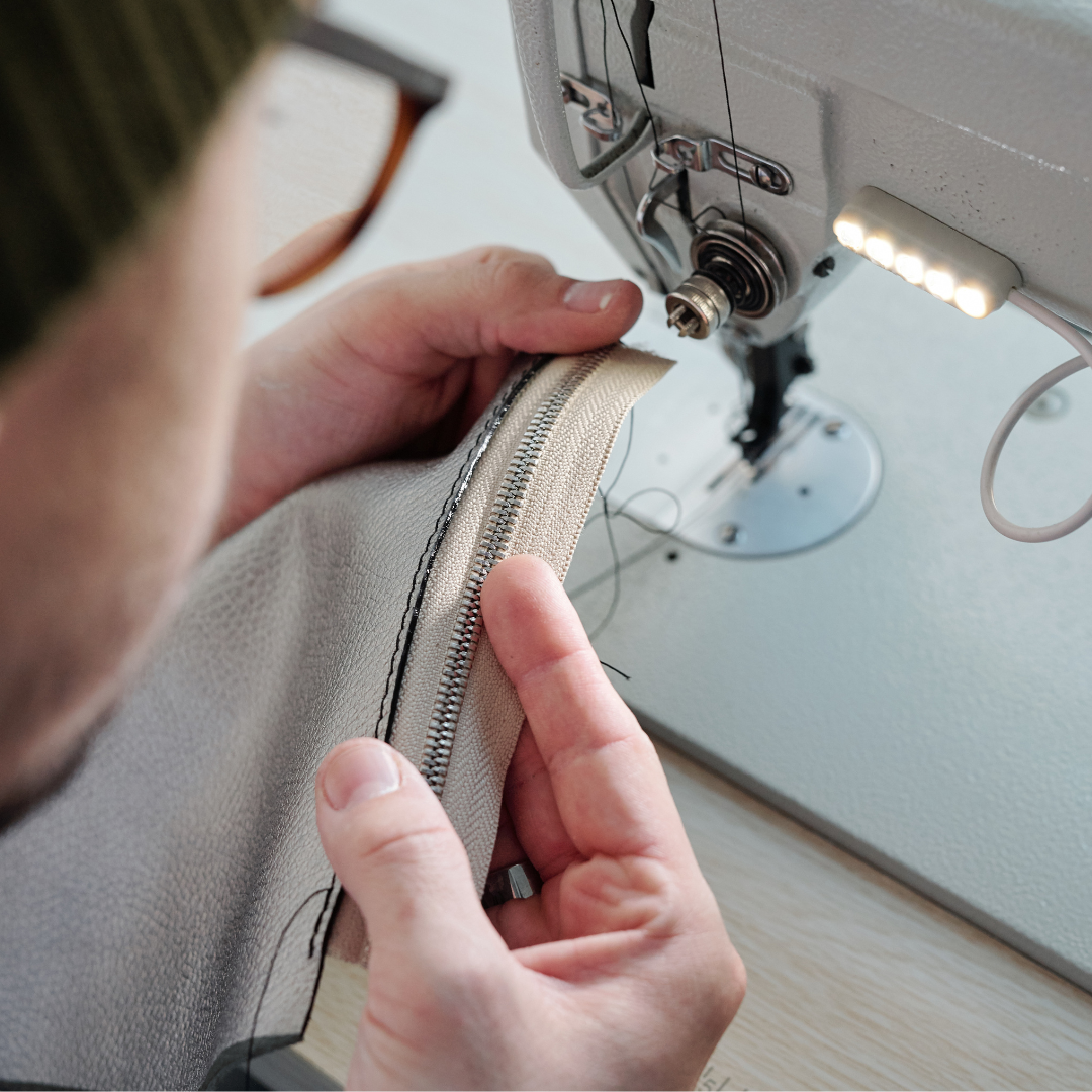 person holding sewed zipper