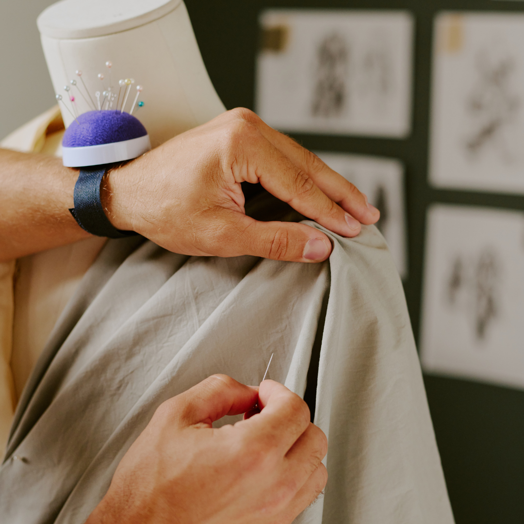 Hands draping fabric to gather and pleat