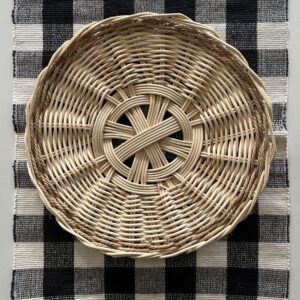 handwoven basket tray on black and white textile